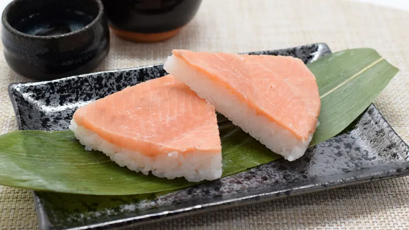 Sliced masu sushi on bamboo